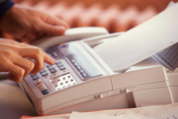 PERSON USING FAX MACHINE IN DETAIL 