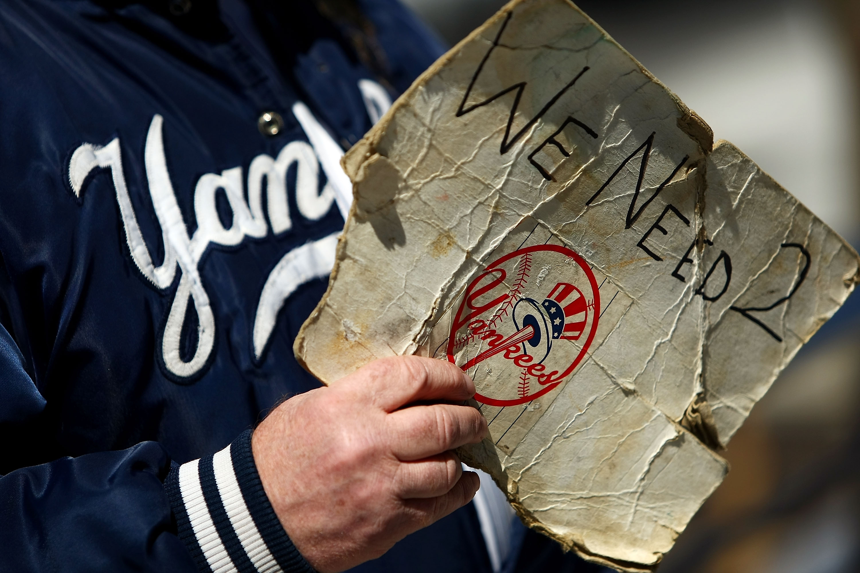 Man Holds Yankees Tickets Sign 