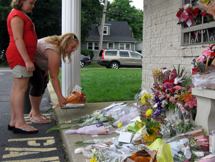Mourners Leave Flowers At Medford Pharmacy 