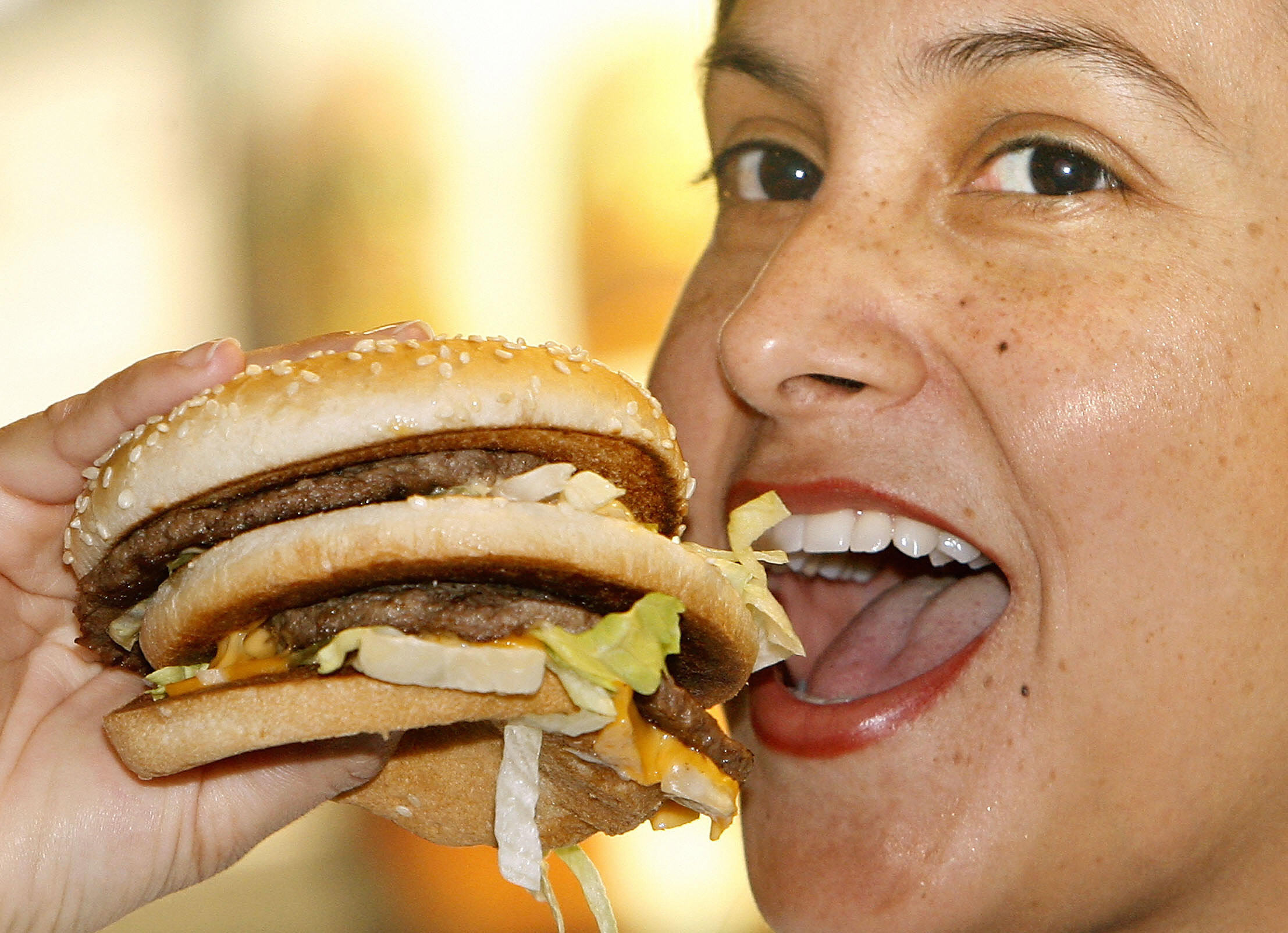 Woman Eating A Cheeseburger 