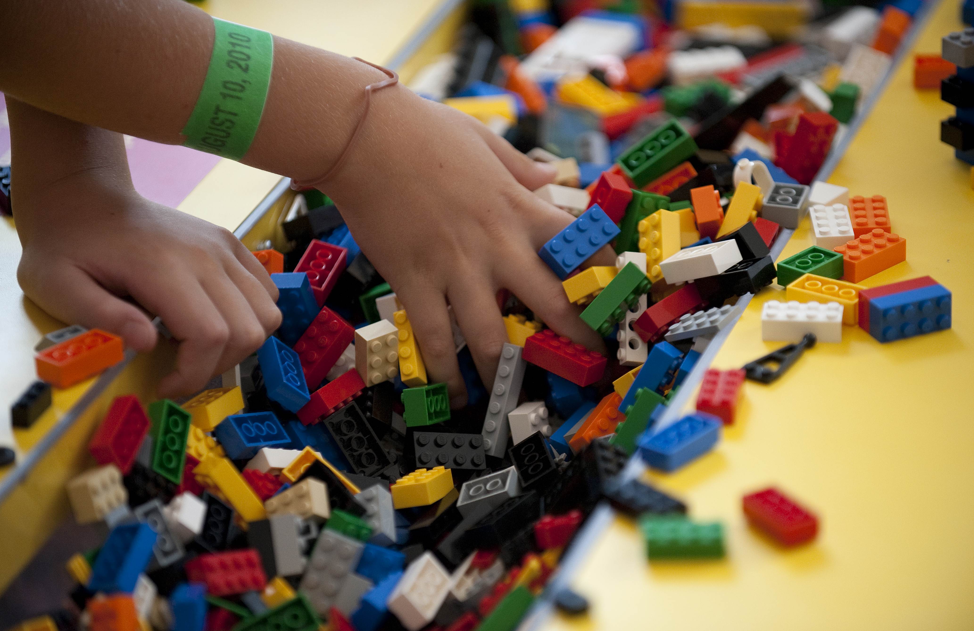 A child plays with LEGO building blocks 