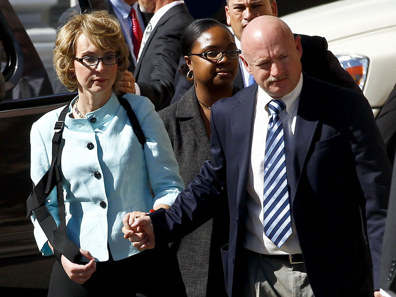Former Democratic Rep. Gabrielle Giffords, left, and her husband Mark Kelly leave after the sentencing of Jared Loughner, in back of U.S. District Court Thursday, Nov. 8, 2012, in Tucson, Ariz.  
