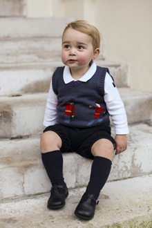 Prince George is seen in late November 2014 in one of the three official Christmas images showing him in a courtyard at Kensington Palace in central London. 