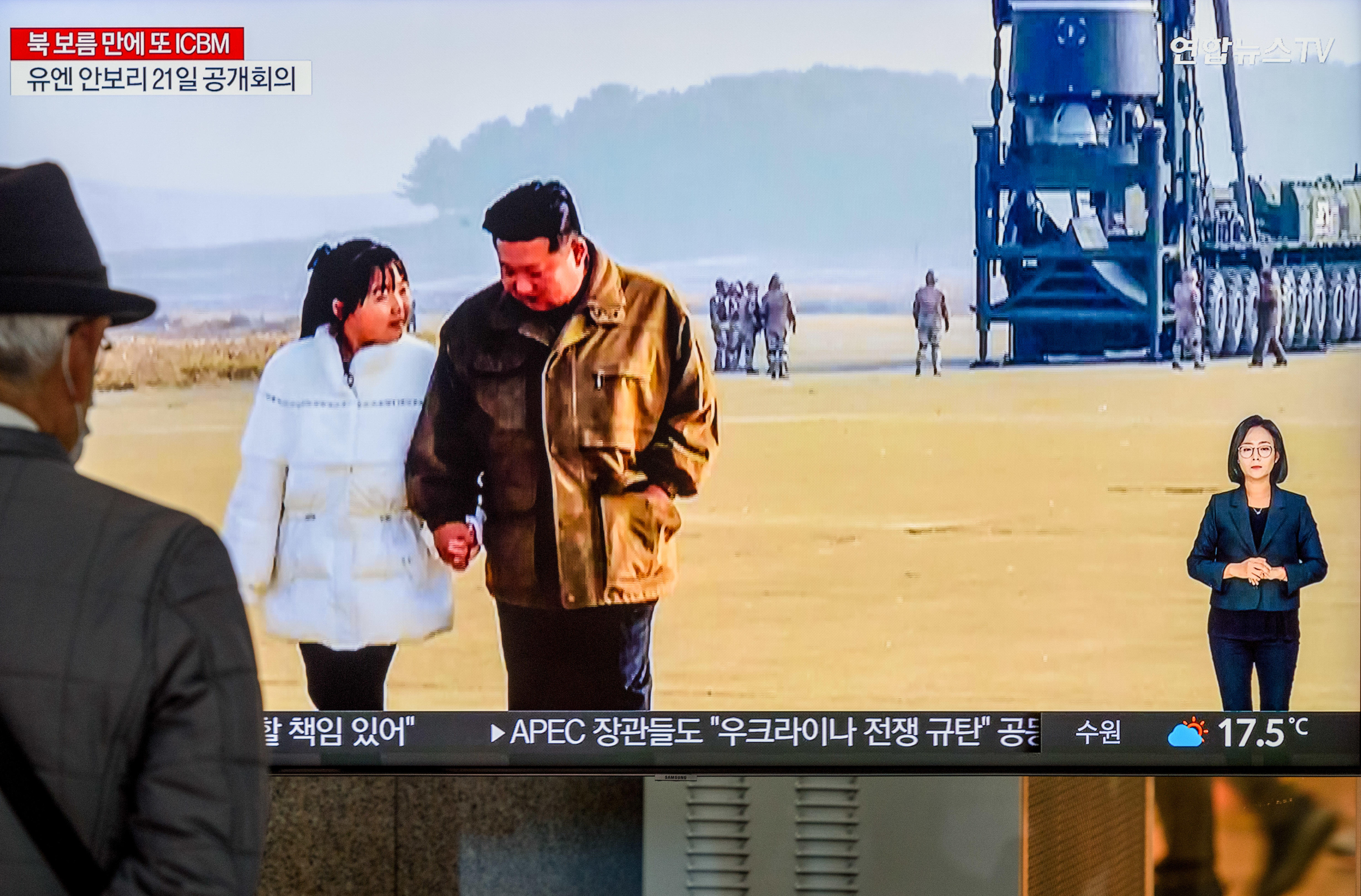 A TV screen shows North Korea's KCNA released pictures of 