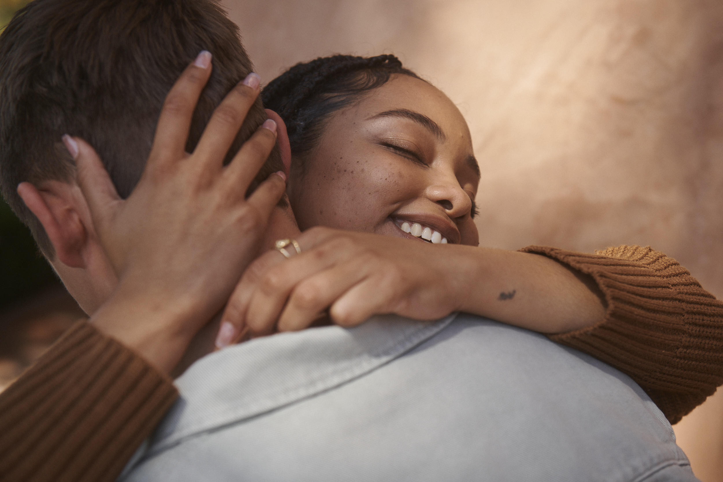 Close-up of young couple hugging. 