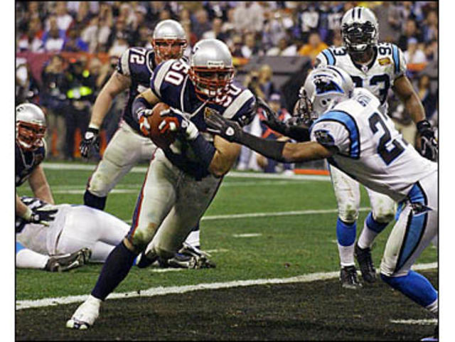 01 Feb 2004: Jake Delhomme of the Carolina Panthers fights off a tackler  during the New England Patriots 32-29 win over the Carolina Panthers in  Super Bowl XXXVIII at Reliant Stadium in