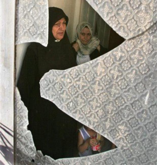 A family are seen through the shattered window 