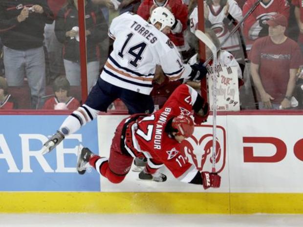 Raffi Torres #14 of the Edmonton Oilers and Rod Brind'Amour #17 of the Carolina Hurricanes clash 