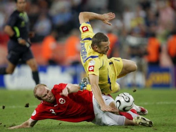 Switzerland's Ludovic Magnin, left, challenges Ukraine's Andriy Shevchenko during the World Cup 
