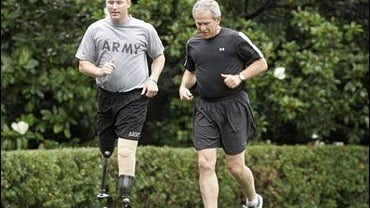 Christian Bagge, a GI who lost his legs in Iraq, jogs with Bush 