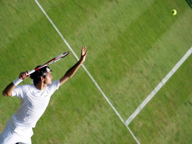 Defending Champion Roger Federer serves to France's Nicolas Mahut 