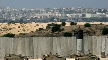 Palestinian resident looks out from his window 