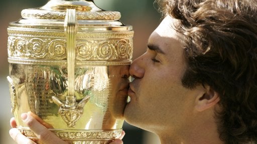 Roger Federer kisses the winners trophy 