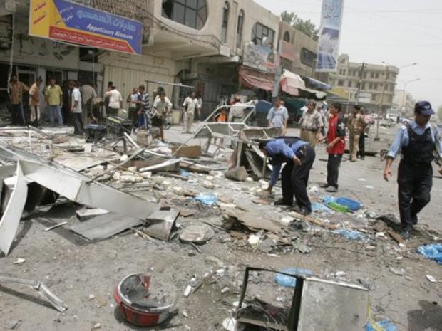 Iraqi police inspect the damage from a suicide bomber, Tuesday, July 11, 2006, in Baghdad, Iraq. 