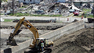 Work is done to repair the damaged levee 