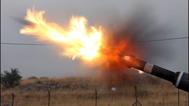 An Israeli mobile artillery unit fires 155mm shells towards Hezbollah targets in southern Lebanon 13 July 2006 