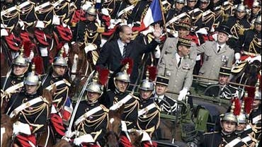 French President Jacques Chirac Waves As He Reviews The Troops 