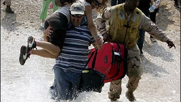 US Marines help bring evacuees on board a LCU (Landing Craft Utility) from a beach in Beirut, Lebanon, Thursday, July 20, 2006. 