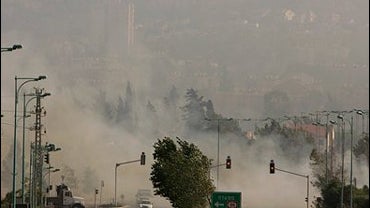 Smoke fills Kiryat Shmona, Israel, as Hezbollah rockets ignite the surrounding forests, 7-24-06 