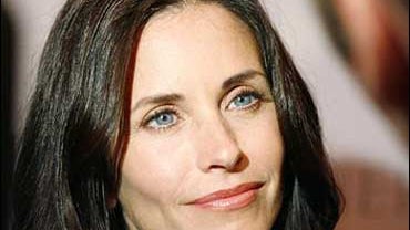 Actress Courteney Cox poses for photographers at the "A Night at the Comedy Store", a fundraiser to benefit the EB Medical Research Foundation, in the Hollywood section of Los Angeles on Monday, Aug. 14, 2006. 