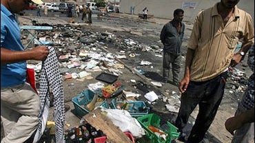 Iraqis search for their belongings, following a bomb explosion, in Baghdad, Iraq, Wednesday Aug.16, 2006. 