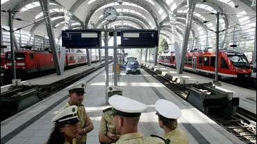 Police officers guard empty platforms at the main station in Kiel, northern Germany, on Saturday, Aug. 19, 2006, as police investigators check for evidence after a suspect was arrested early Saturday at the station. 