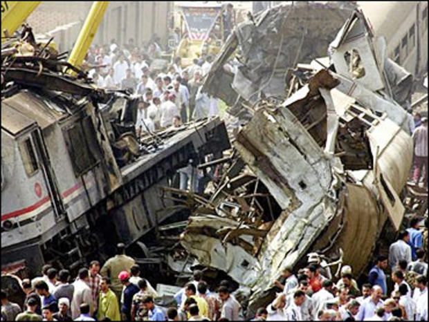 People gather at the site of a train crash in rail station of Qalyoub, north of Cairo, Egypt 