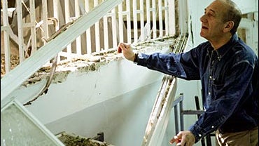 Israeli Prime Minister Ehud Olmert visits a damaged class room that was directly hit by rocket fired by Hezbollah guerrillas 