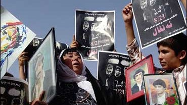Iraqi Kurds shout anti-Saddam Hussein slogans during a demonstration, in the northern Kurdish city of Sulaimaniyah, 160 miles northeast of Baghdad, Iraq, Monday Aug. 21, 2006. 