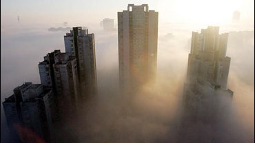 Skyscrapers stand amid dense fog, Pyongyang, North Korea, 11-24-05 