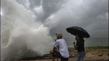 People watch the strong waves produced by Tropical Storm Ernesto in Santo Domingo, Dominican Republic, Saturday, Aug. 26, 2006. 