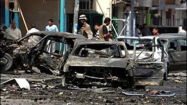 Iraqi army soldiers inspect the site after a car bomb explosion, in Baghdad, Iraq 