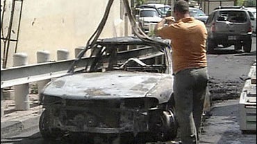 Burnt out car is removed after attack on US Embassy 