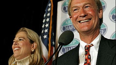 Sen. Lincoln Chafee, R-RI, and his wife Stephanie smile as they listen to the cheers of supporters at his election night rally in Providence, RI. 