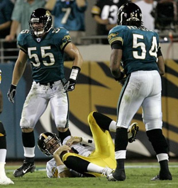 Pittsburgh Steelers quarterback Ben Roethlisberger, center, lies on the ground after being sacked between Jacksonville Jaguars defenders, Nick Greisen, left, and Mike Peterson, during the third quarter 
