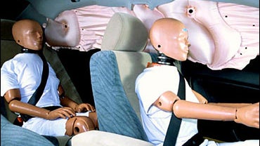 Side curtain air bags deploy in test car with dummies 