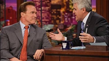 California Gov. Arnold Schwarzenegger, left, jokes with "Tonight Show" host Jay Leno, Oct. 11, 2006, that TV ads trying to connect him to President Bush are far from the mark.  "To link me to George Bush," said Schwarzenegger, "is like linking me to an Os 