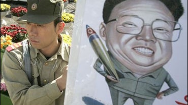 A former South Korean intelligence agent, wearing a North Korean uniform, demonstrates in front of the Defense Ministry in Seoul, Oct. 13, 2006, volunteering to go North and destroy any nuclear weapons the country may have. 