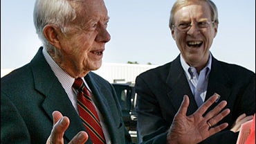 Former President Jimmy Carter, center, and his son Jack Carter, center right, Democratic nominee for the U.S. Senate, talk to supporters during a campaign stop in Las Vegas 