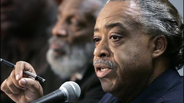 Longtime political activist Dick Gregory (left) listens as the Rev. Al Sharpton talks about the need for black churchgoers to focus more political attention on social justice issues, Indianapolis, Ind., Oct. 31, 2006. 