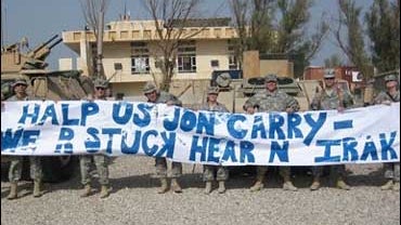 Soldiers in Iraq, Nov. 2006, hold up a sign mocking recent comments by Sen. John Kerry. 