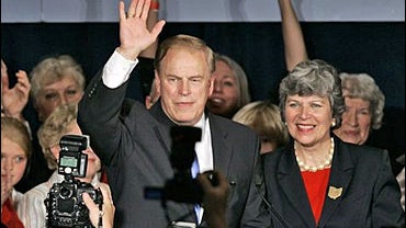 Democratic U.S. Rep. Ted Strickland along with his wife, Frances, waves to supporters before giving a victory speech 