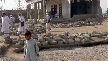 people look at bombed school 