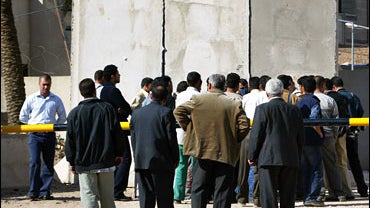 Relatives of the higher education ministry's employees gather outside the ministry's main building asking about the fate of those kidnapped in Baghdad 