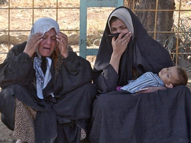 Iraqi women grieve over the death of their relative killed in sectarian violence, at the morgue yard in Baqouba 