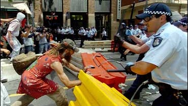 Protestors rush at a police blockade during the G20 finance summit in Melbourne 