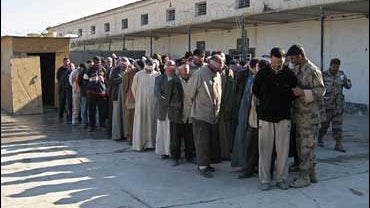 Blindfolded detainees are held at the Iraqi Army base in Baqouba, 35 miles northeast of Baghdad, Iraq, Wednesday, Nov. 29, 2006. 