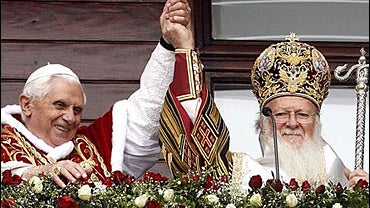 Pope Benedict XVI, left, and Ecumenical Patriarch Bartholomew I appear at a balcony of the Ecumenical Patriarchate to bless the faithful, respectively in Latin and Greek, after attending together the Divine Liturgy in the nearby Church of St. George in Is 