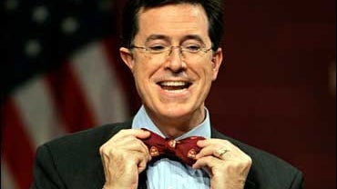 Comedian Steven Colbert puts on a Harvard bow tie 