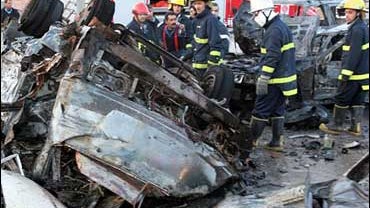 Firefighters look at the scene outside Al-Mustansriya university in Baghdad, Iraq, Tuesday Jan. 16, 2007. 